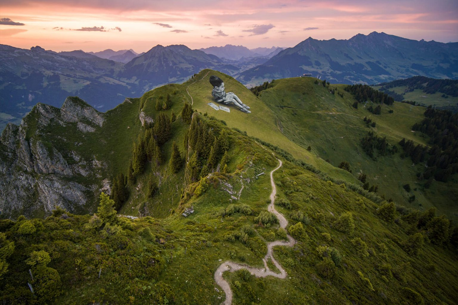 Gargantuan children on top of mountains by street artist Saype