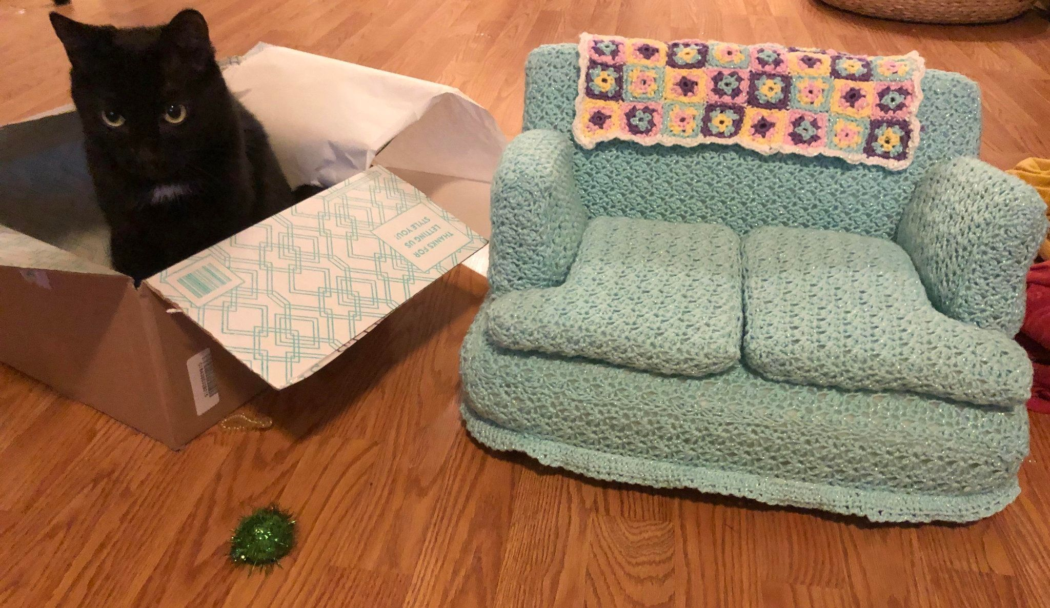 Cats relaxing on tiny crocheted couches